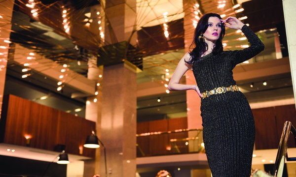 Knitted one shoulder top, $195, Knitted miniskirt, $225, from Karen Millen; Gold belt, $125, from Woolcock Reynella; Cinquante Desert Sky brass earring, $168, from One Rundle Trading Co.