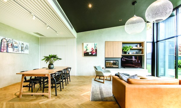 Parallel timber battens create a striking architectural feature in the extension, as the roofline angles upwards out to the garden, while each piece of the light European oak parquetry was laid individually. 