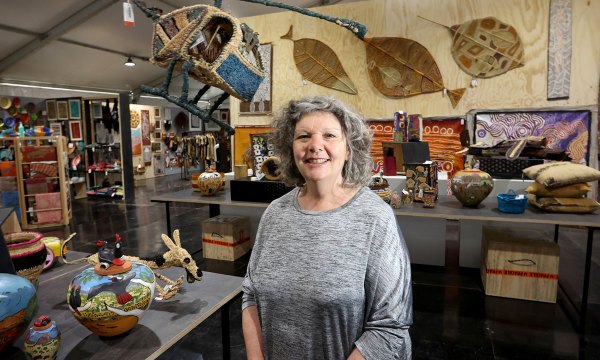 Tarnanthi director Nici Cumpston with works for sale at the art fair, including (front left) ceramics from the Hermannsburg Potters.