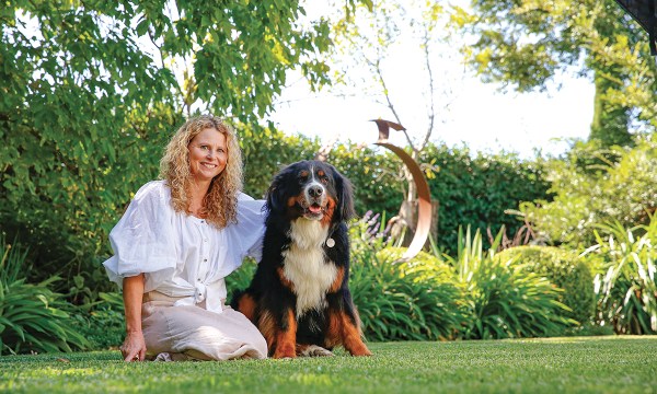 Sally Blackwood with her Bernese mountain dog Winnie, who also enjoys the beautiful garden.