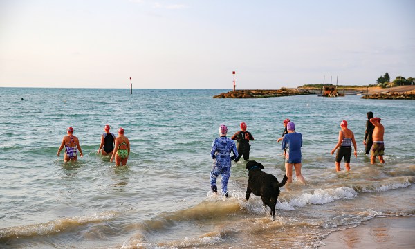 Swimmers brave the conditions rain, hail or shine.