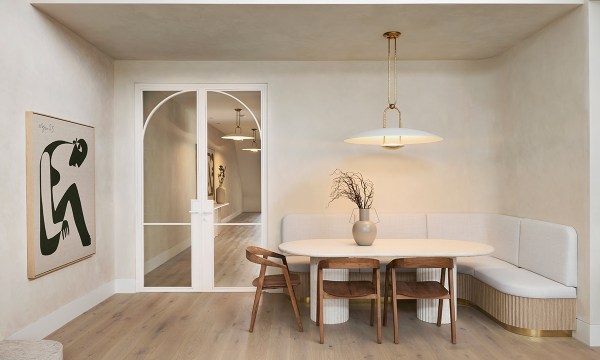 Alisa used booth seating in her dining area to save space. The Ralph Lauren light sits atop a table Alisa imported, and dining chairs from Satara.