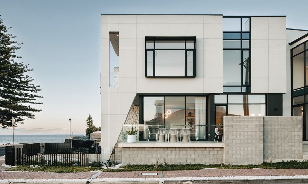 A view from the side of the home shows the incredible beachfront vistas and the external architectural features.