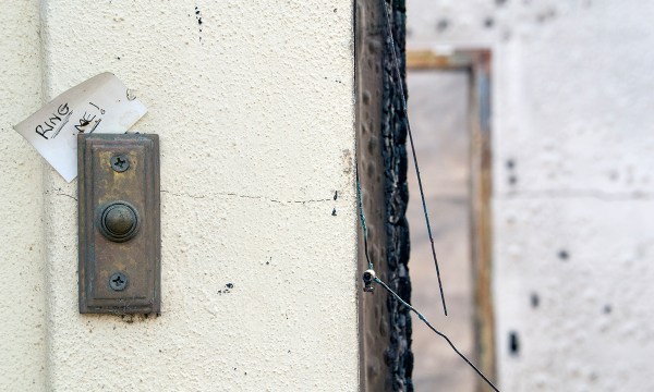 The family’s possessions were destroyed, but somehow a Post-It Note tucked behind the doorbell survived the fire.  